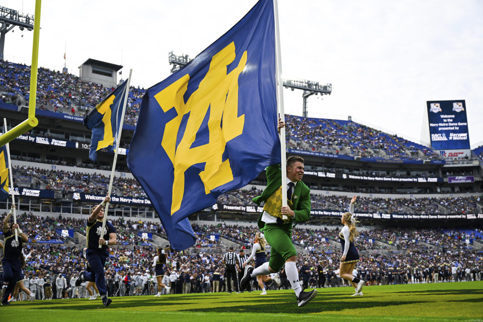The Notre Dame Leprechaun runs a flag after touchdown during the first half of with an NCAA college football game against Navy, Saturday, Nov. 12, 2022, in Baltimore. (AP Photo/Terrance Williams)