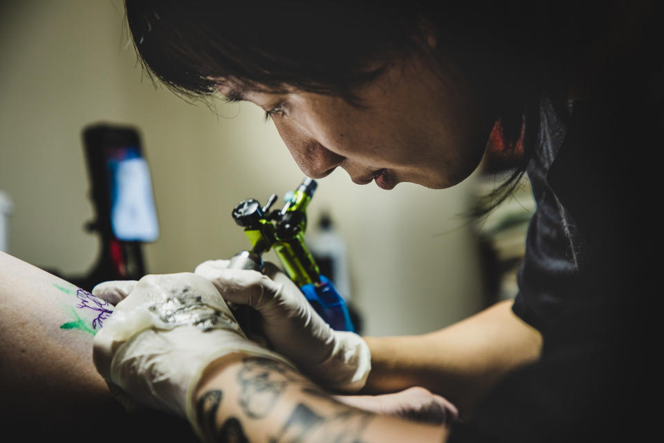 A tattoo artist working