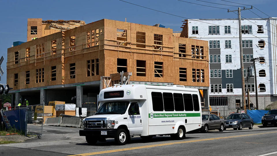 A MetroWest Regional Transit Authority bus passes by apartments under construction last August near the MWRTA hub on Blandin Avenue in Framingham.