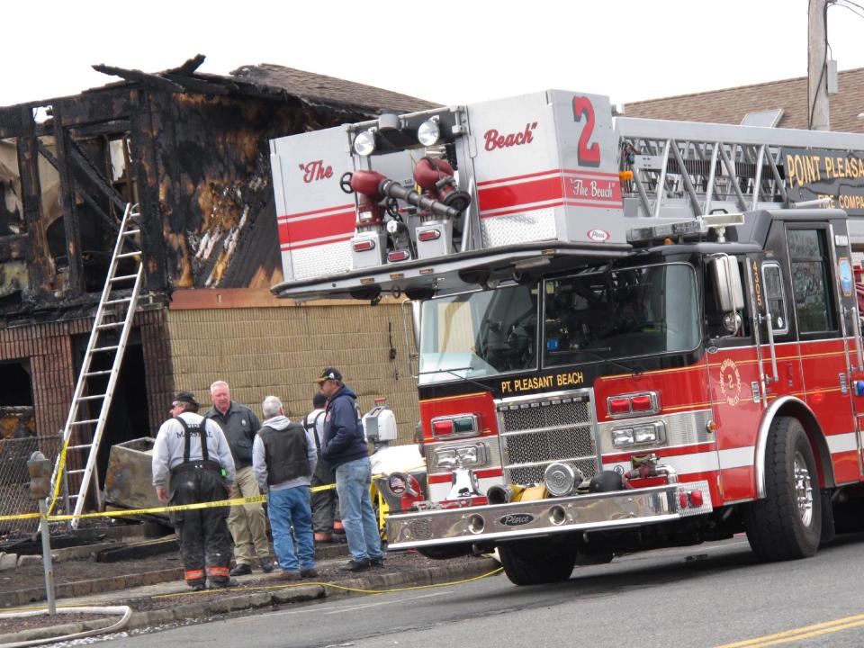 Investigators examine the remains of a motel in Point Pleasant Beach N.J., on Saturday, March 22, 2014. Autopsies were being conducted Saturday on the four people who died in a fire at a Jersey shore motel that housed some victims who lost their homes when Superstorm Sandy hit. Al Della Fave, a spokesman for the Ocean County Prosecutor's Office, said the medical examiner's office is trying to identify the victims and determine how they died in the blaze at the Mariner's Cove Motor Inn in Point Pleasant Beach early Friday morning. An intense investigation into the cause of the blaze began Friday afternoon after the last of the four bodies was removed. Eight people were injured in the fire. The probe into the cause is expected to take several days. (AP Photo/Wayne Parry)