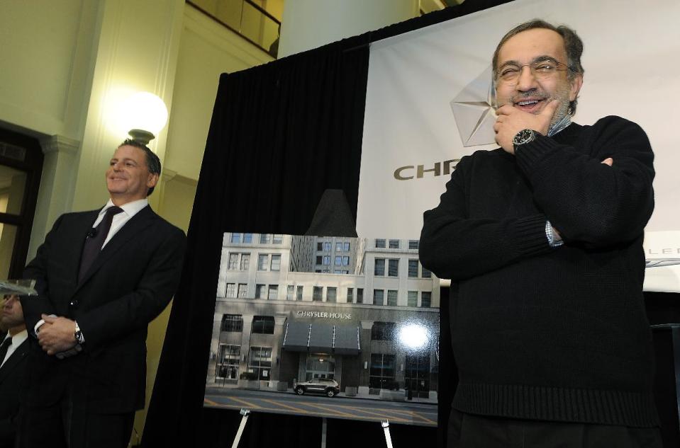 Chairman of Rock Ventures and Quicken Loans Dan Gilbert, left, and Fiat-Chrysler CEO Sergio Marchionne stand with a rendering of the Chrysler name on the front of the Dime Building as they answer questions at a news conference to announce that Chrysler is setting up a an office for Marchionne and up to 70 staffers in downtown Detroit, on April 30, 2012. (AP Photo/The Detroit News, Daniel Mears)