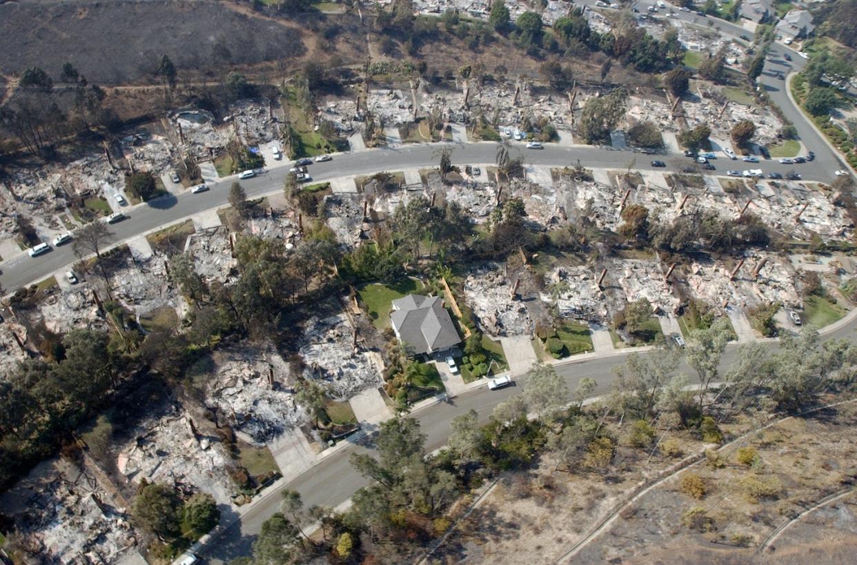 Wildfires can destroy hundreds of homes within hours. <a href="https://www.gettyimages.com/detail/news-photo/view-29-october-2003-from-a-sea-king-helicopter-assigned-to-news-photo/1249142472" rel="nofollow noopener" target="_blank" data-ylk="slk:PH2(AW/SW) Michael J. Pusnik, Jr / Navy Visual News Service / AFP via Getty Images;elm:context_link;itc:0;sec:content-canvas" class="link ">PH2(AW/SW) Michael J. Pusnik, Jr / Navy Visual News Service / AFP via Getty Images</a>