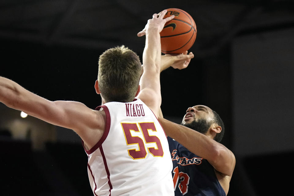 Cal State Fullerton forward Vincent Lee, right, has his shot blocked by Southern California forward Iaroslav Niagu during the first half of an NCAA college basketball game Wednesday, Dec. 7, 2022, in Los Angeles. (AP Photo/Mark J. Terrill)