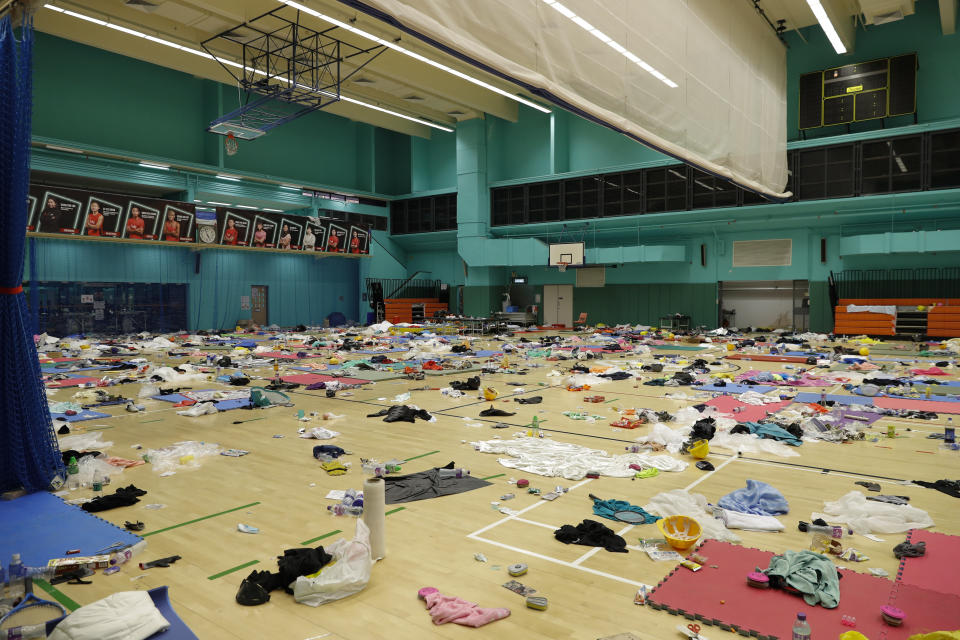 Belongings of protesters are left in the gymnasium of the Polytechnic University in Hong Kong, Thursday, Nov. 21, 2019. A small group of protesters refused to leave the Hong Kong Polytechnic University, the remnants of hundreds who took over the campus for several days. (AP Photo/Vincent Thian)