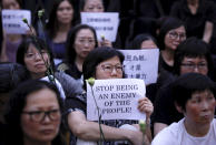 Hundreds of mothers protest against the amendments to the extradition law after Wednesday's violent protest in Hong Kong on Friday, June 14, 2019. Calm appeared to have returned to Hong Kong after days of protests by students and human rights activists opposed to a bill that would allow suspects to be tried in mainland Chinese courts. (AP Photo/Vincent Yu)