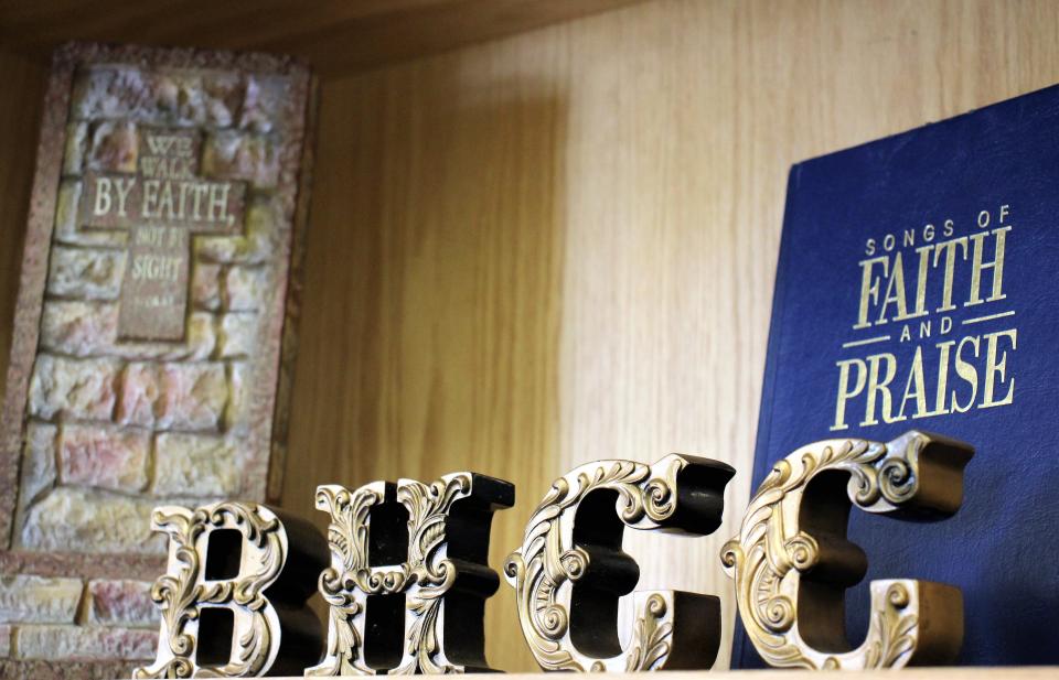 A bookcase display at the entrance to the new Brook Hollow Christian Church includes the letters BHCC. April 3 2022