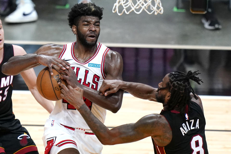 Chicago Bulls forward Patrick Williams, left, loses control of the ball as Miami Heat forward Trevor Ariza (8) defends during the second half of an NBA basketball game, Monday, April 26, 2021, in Miami. (AP Photo/Lynne Sladky)