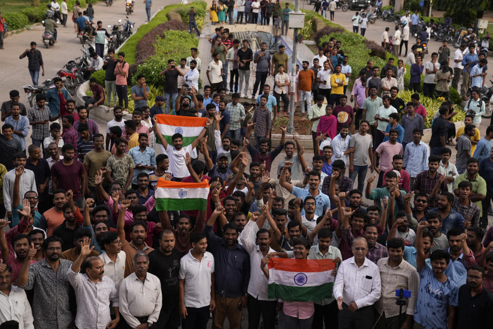 Students celebrate the successful landing of Chandrayaan-3, or "moon craft" while watching a live telecast at Omani University in Hyderabad, India, Wednesday, Aug. 23, 2023. India has landed a spacecraft near the moon's south pole, an unchartered territory that scientists believe could hold vital reserves of frozen water and precious elements, as the country cements its growing prowess in space and technology. (AP Photo/Mahesh Kumar A.)