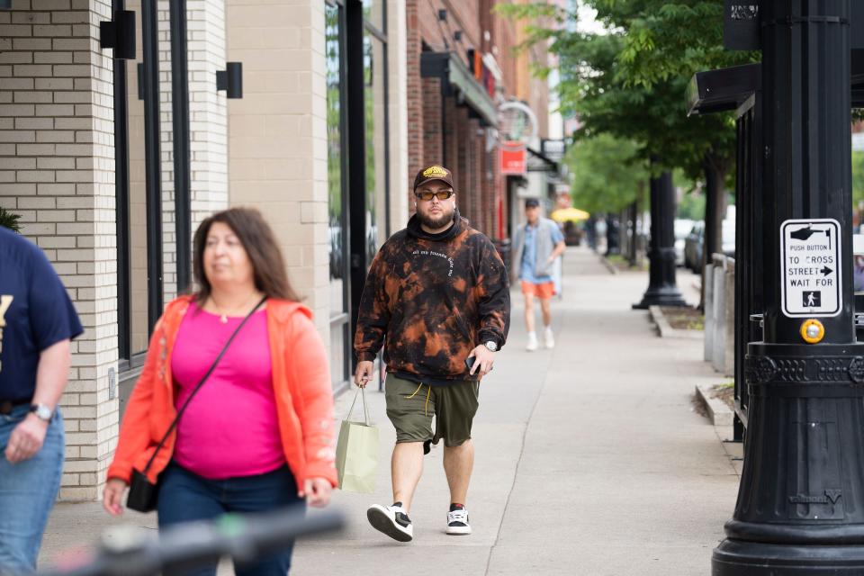 Angel Lopez, 33, walks through the Short North on Monday. The Grammy-winning music producer said he was out and about in the Short North when both of the recent shootings occurred, though he didn't witness them directly.