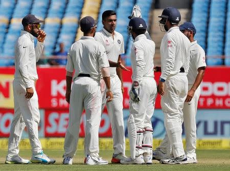 Cricket - India v England - First Test cricket match - Saurashtra Cricket Association Stadium, Rajkot - 9/11/16. India's Ravichandran Ashwin (3rd L) is congratulated by his teammates after taking the wicket of England's Ben Duckett. REUTERS/Amit Dave