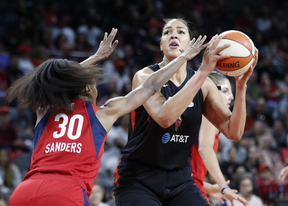 Las Vegas Aces' Liz Cambage shoots against Washington Mystics' LaToya Sanders during the first half of Game 4 of a WNBA playoff basketball series Tuesday, Sept. 24, 2019, in Las Vegas. (AP Photo/John Locher)