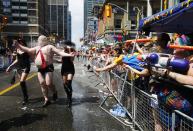 A man dressed to mock Toronto Mayor Rob Ford gets sprayed by water guns at the" WorldPride" gay pride Parade in Toronto June 29, 2014. Toronto is hosting WorldPride, a week-long event that celebrates the lesbian, gay, bisexual and transgender (LGBT) community. REUTERS/Mark Blinch (CANADA - Tags: SOCIETY)