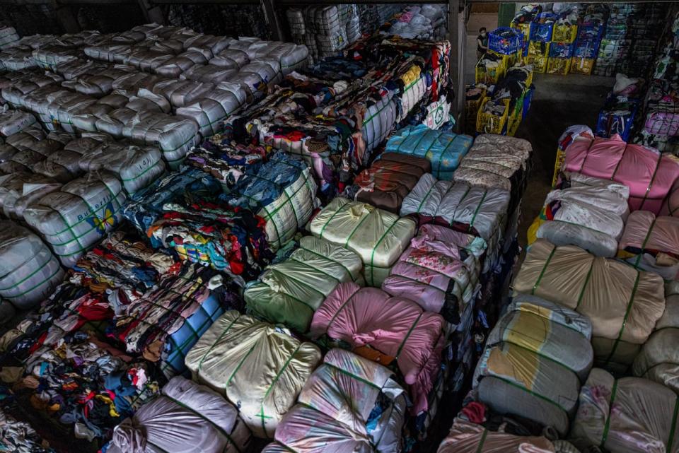 Bales of sorted second-hand clothes are seen being piled up at a facility operated by Zheng-chuan textile recycling factory on July 15, 2022 in New Taipei City, Taiwan. Canadians toss nearly 500 million kilograms of fabric items every year, according to researchers at the University of Waterloo.   