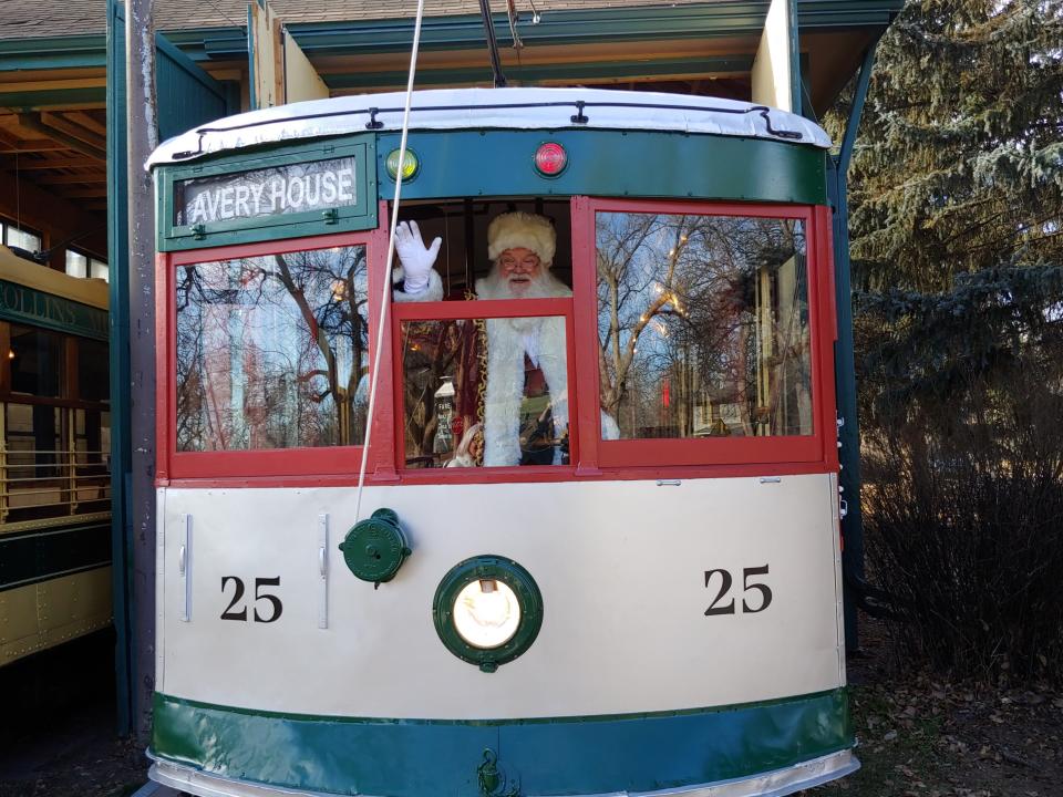 Santa waves from Fort Collins trolley car 25. The jolly fellow will be taking the trolley to the Fort Collins Municipal Railway Society's West Mountain Avenue trolley barn for its holiday open house Dec. 9, 2023.