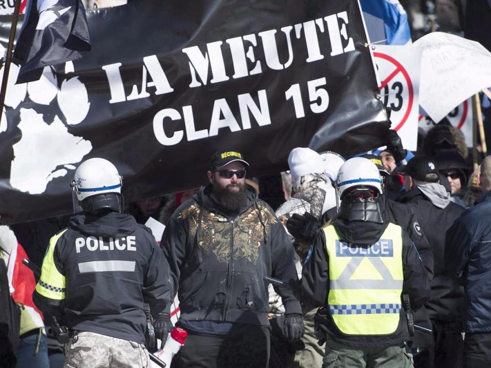 Police hold back far-right protesters during a demonstration in Montreal on Saturday, March 4, 2017. (Graham Hughes/The Canadian Press - image credit)