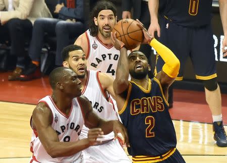 May 21, 2016; Toronto, Ontario, CAN; Cleveland Cavaliers guard Kyrie Irving (2) goes up for a basket past Toronto Raptors center Bismack Biyombo (8), guard Cory Joseph (6), and forward Luis Scola (4) in game three of the Eastern conference finals of the NBA Playoffs at Air Canada Centre. Mandatory Credit: Dan Hamilton-USA TODAY Sports