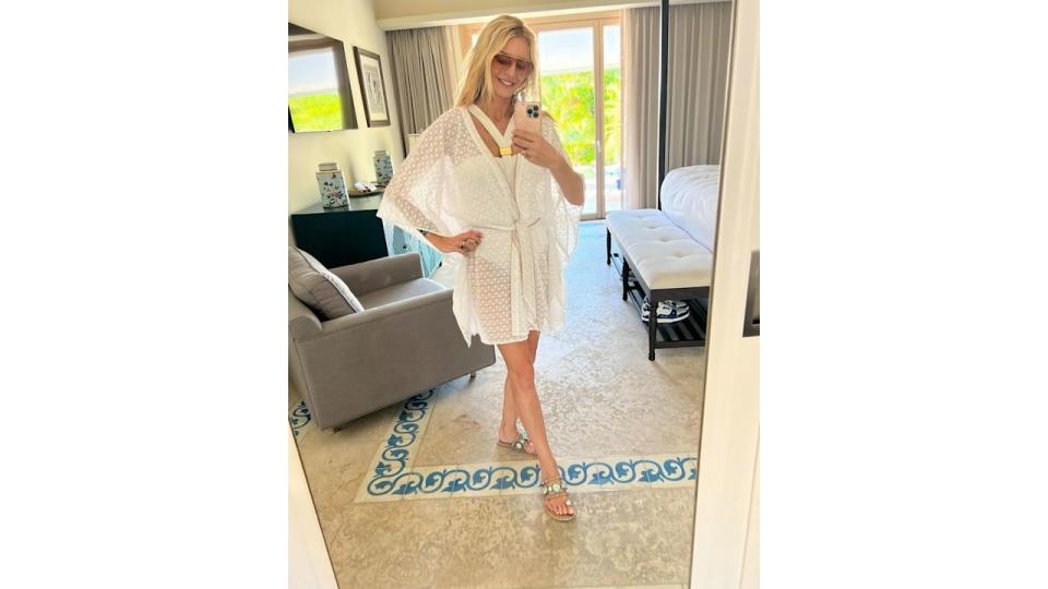 tess daly wearing white swimsuit and beach cover-up 