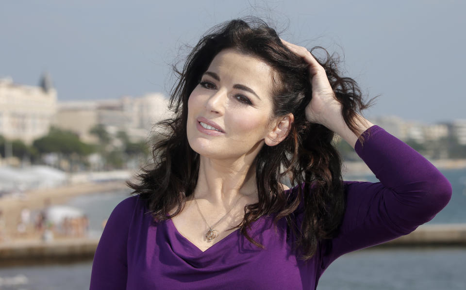 FILE - In this Tuesday, Oct. 9, 2012 file photo, food writer, journalist and broadcaster, Nigella Lawson of Britain poses during the 28th International Film and Programme Market for TV, Video, Cable and Satellite in Cannes, southeastern France. In summer 2013, photos of her husband appearing to choke her surfaced. Then two former employees accused of using the coupleâ€™s credit cards for more than $1 million in fraudulent charges claiming she had sanctioned their spending to hush them up about her heavy drug use. (AP Photo/Lionel Cironneau, File)