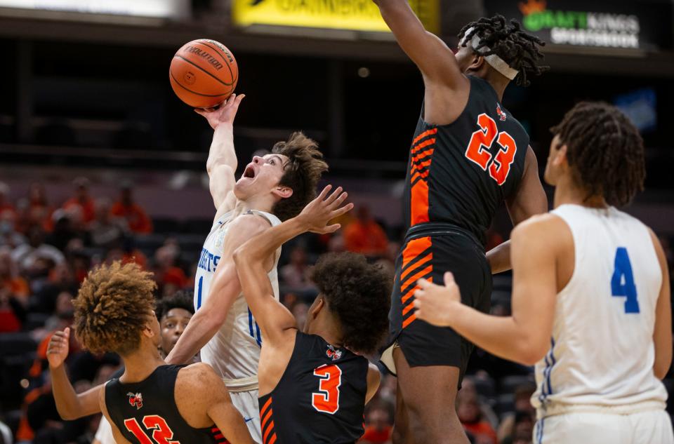 Marian's Deaglan Sullivan (1) goes up for a shot in a pack of Beech Grove defenders during the 3A boys basketball state championship game on Saturday, March 26, 2022, at Gainbridge Fieldhouse in Indianapolis. 