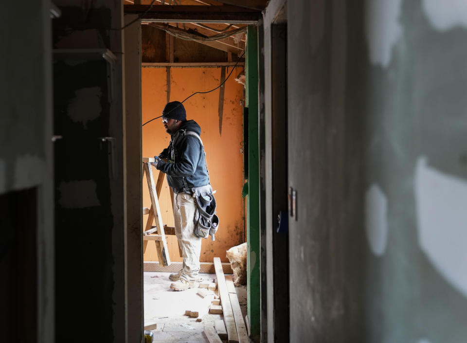 Daniel Zarate works on renovating a mobile home for his mother in Bob’s and Jamestown Homeowners Cooperative, a resident-owned mobile home park in Lakewood, Wash., on Saturday, March 25, 2023. When residents learned the park’s owner was looking to sell, they formed a cooperative and bought it themselves amid worries it would be redeveloped. Since becoming owners in September 2022, residents have worked together to manage and maintain the park. (AP Photo/Lindsey Wasson)