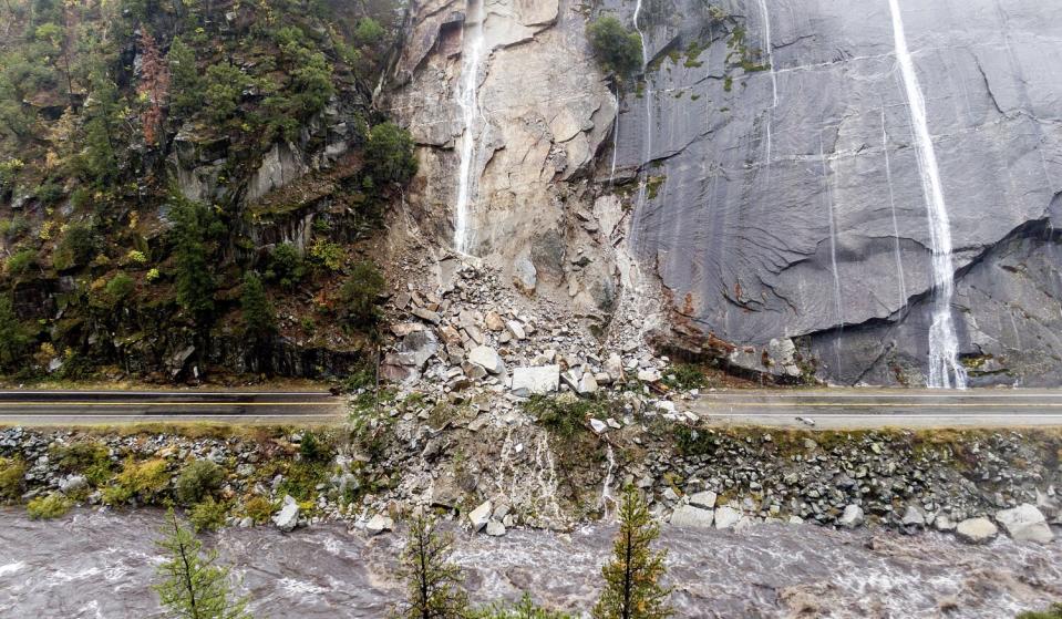 Rocks and vegetation cover Highway 70 after a land collapse in the Dixie fire zone in Plumas County.