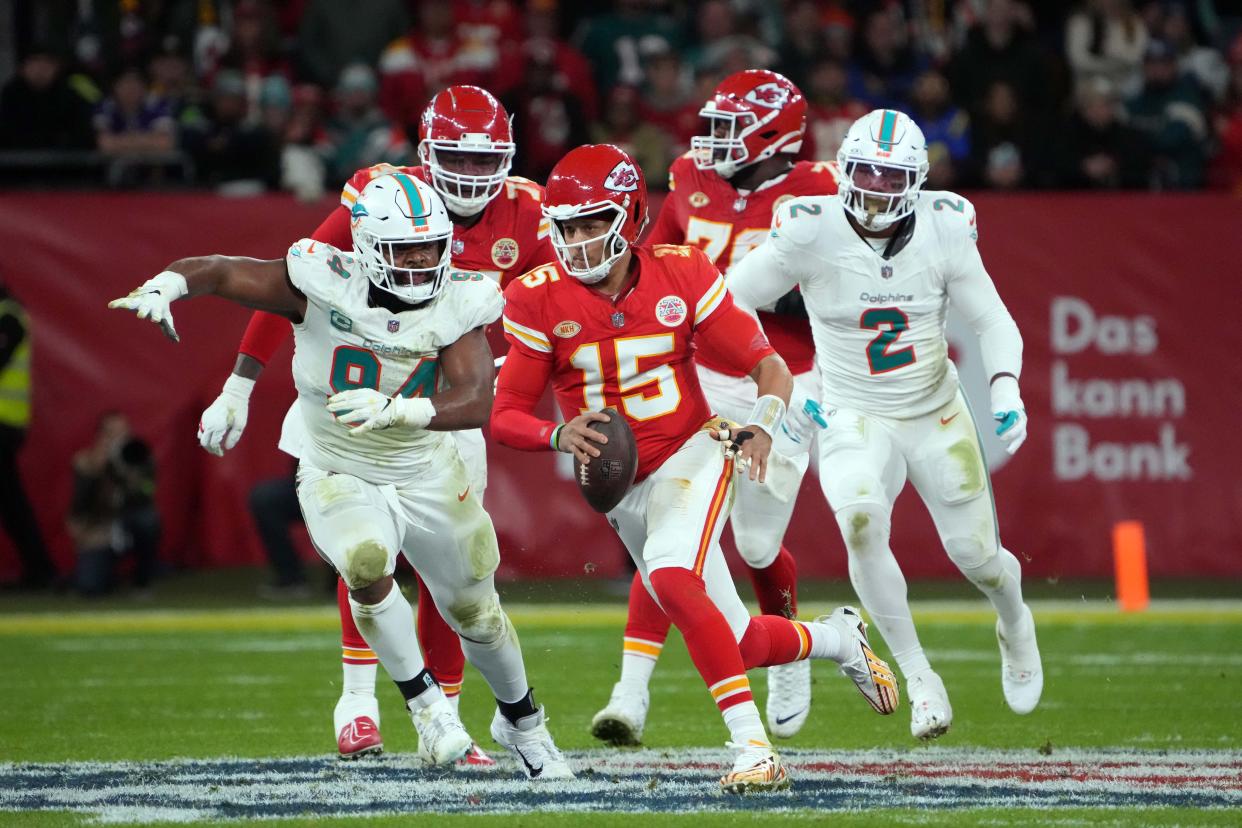 Chiefs quarterback Patrick Mahomes (15) carries the ball against Dolphins defensive tackle Christian Wilkins (94) and linebacker Bradley Chubb (2) during the first half of their regular-season game at Deutsche Bank Park in Frankfurt, Germany on Nov. 5, 2023.