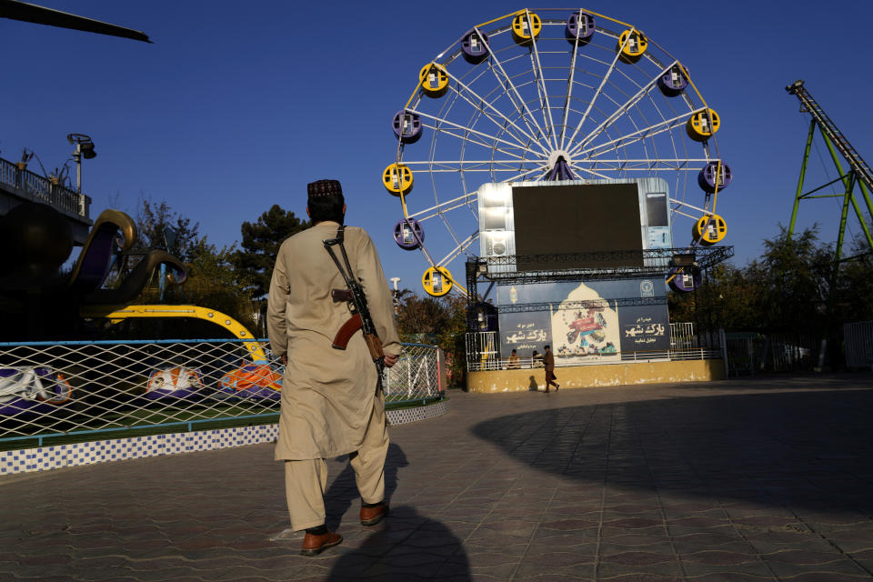 FILE- A Taliban fighter stands guard in an amusement park in Kabul, Afghanistan, Thursday, Nov. 10, 2022. (AP Photo/Ebrahim Noroozi, File)
