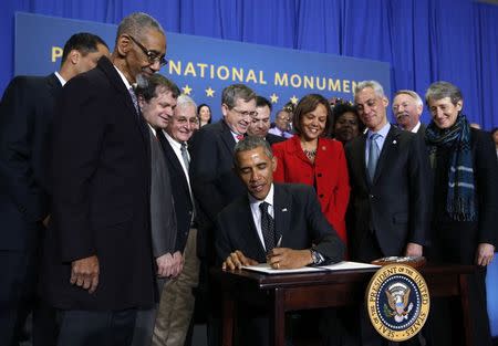 U.S. President Barack Obama signs a proclamation designating three new national monuments during an event in Chicago February 19, 2015. REUTERS/Kevin Lamarque