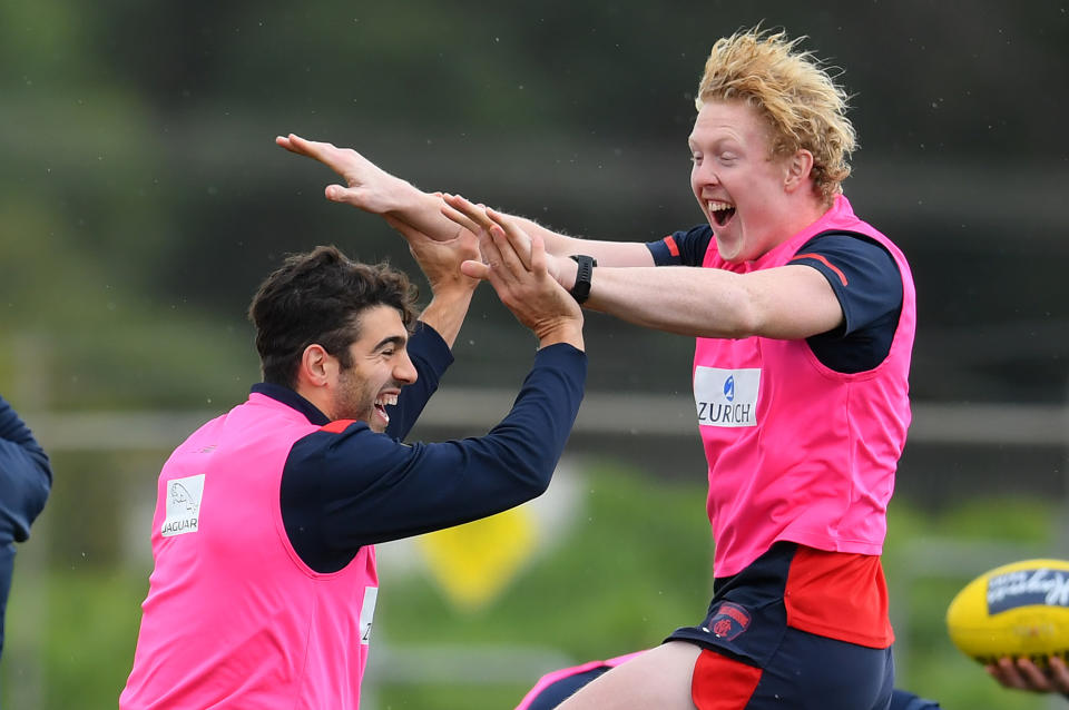 MELBOURNE, AUSTRALIA - MAY 19: Christian Petracca and Clayton Oliver of the Demons celebrate during a Melbourne Demons AFL training session at Casey Fields on May 19, 2020 in Melbourne, Australia. (Photo by Quinn Rooney/Getty Images)