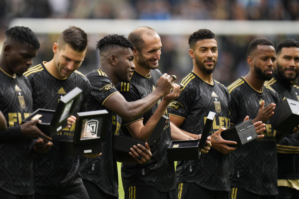 Los Angeles FC players stand on the field with their 2022 MLS Championship rings before the team's soccer match against the Portland Timbers Saturday, March 4, 2023, in Los Angeles. (AP Photo/Jae C. Hong)