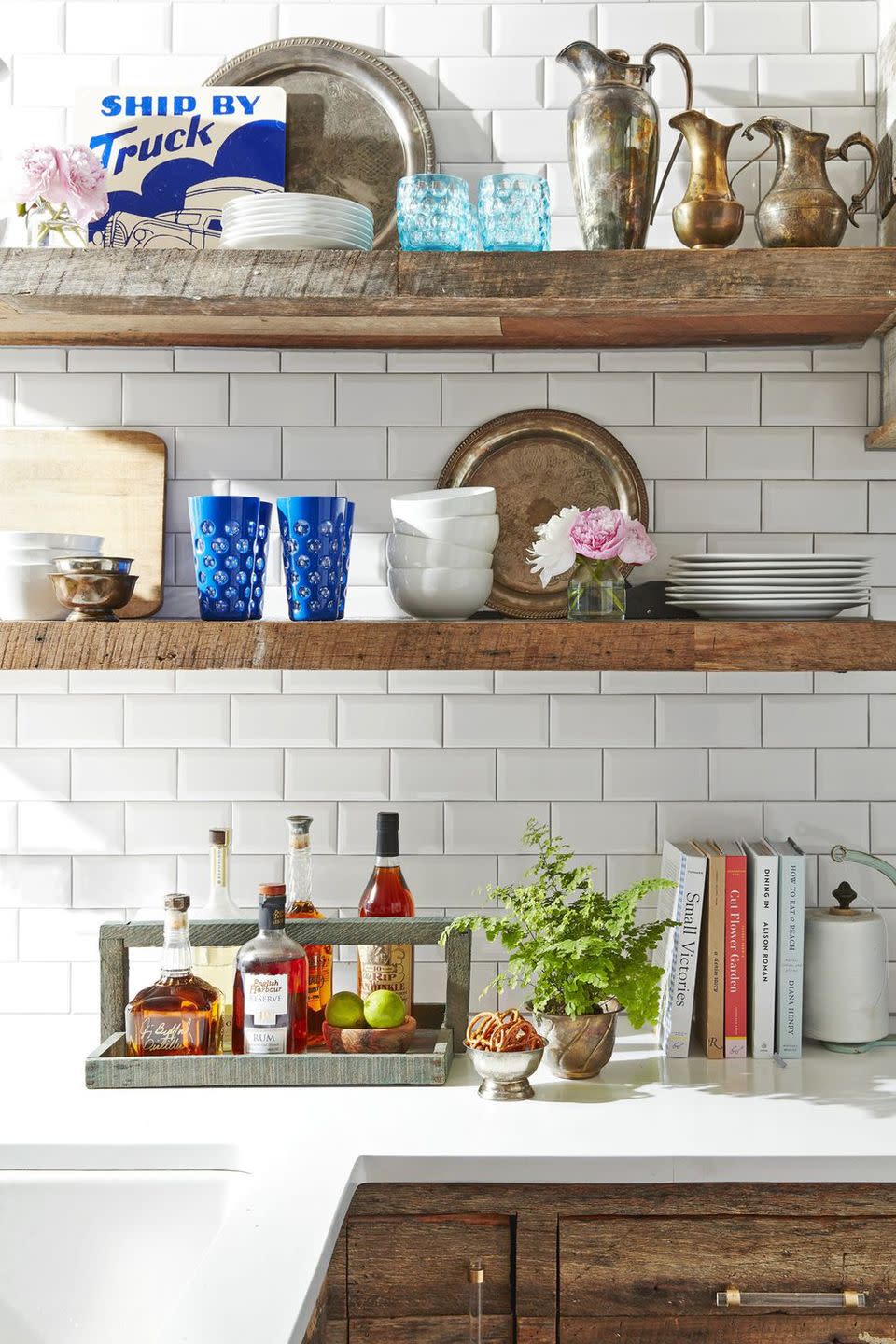 kitchen with open wooden shelving filled with antique finds