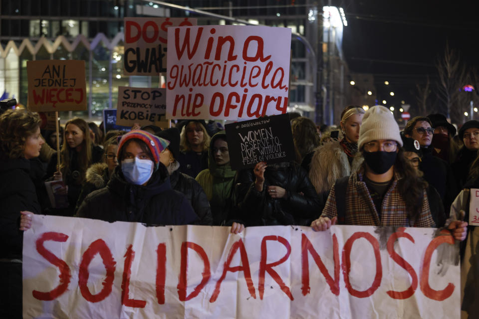 People march in silence to commemorate Lizaveta, a 25-year-old Belarusian woman who died after a being brutally attacked and raped on the streets of Warsaw last month, in Warsaw Poland, Wednesday, March 6, 2024. The crime has shocked people across Poland. Poles, Belarusians and Ukrainians gathered at the site of the crime in downtown Warsaw, placing flowers and lighting candles in honor of the woman known only as Lizaveta, or Liza. (AP Photo/Michal Dyjuk)