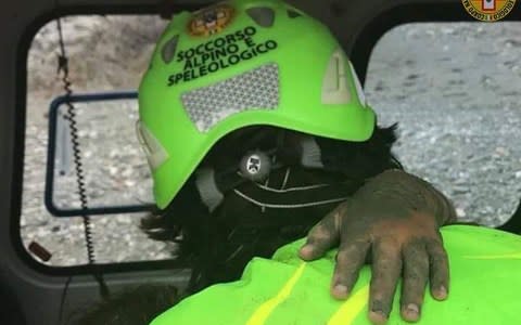 The hand of the eight year old girl on the shoulder of an alpine rescue specialist - Credit: Twitter
