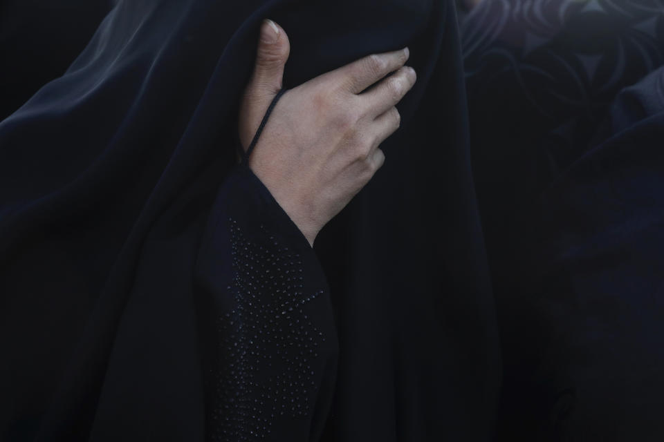 A relative weeps during a funeral procession for a oved one, a Covid-19 victim, at Behesht-e-Masoumeh cemetery just outside the city of Qom, some 80 miles (125 kilometers) south of the capital Tehran, Iran, Wednesday, Sept. 15, 2021. (AP Photo/Vahid Salemi)
