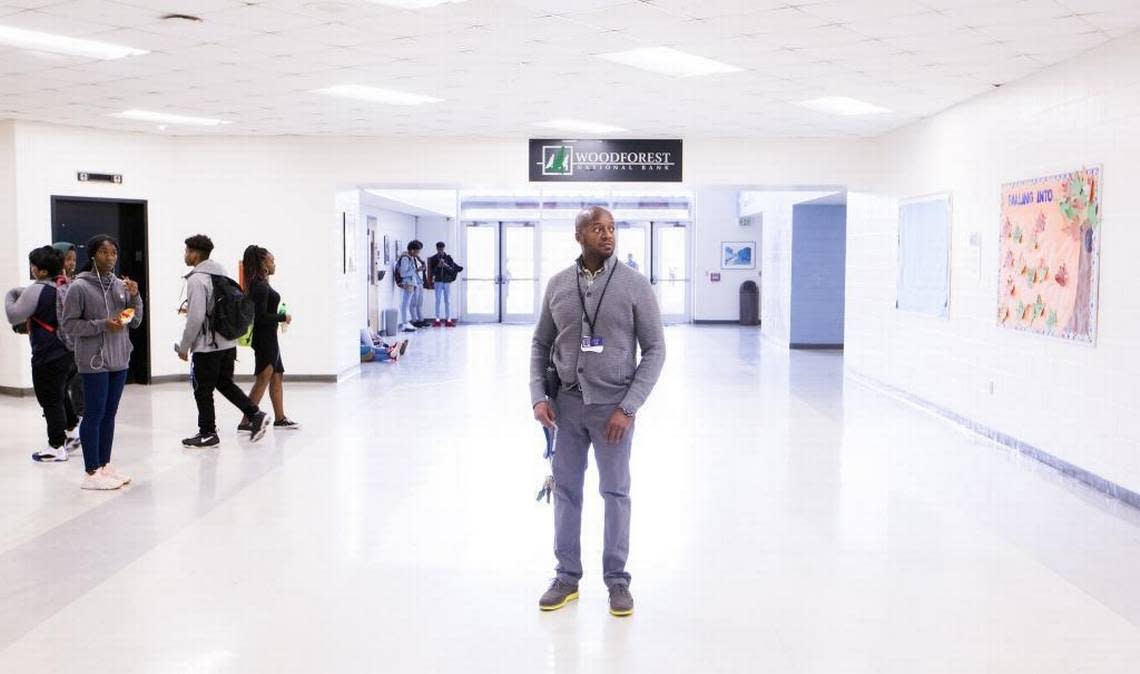 Hillside High School Principal William Logan watches over students during lunchbreak in the school’s lobby.