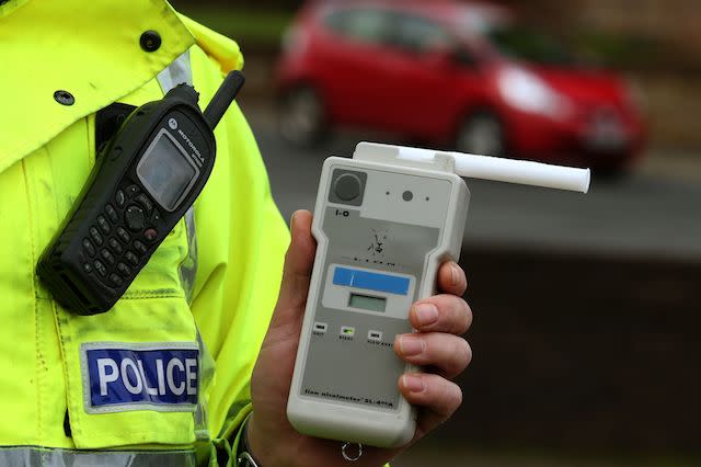 File photo dated 03/12/2014 of a Road Traffic constable holding a breathalyser as the number of motorists involved in accidents who subsequently failed a drink-drive breath test has risen for the first time in 10 years.