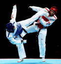 LONDON, ENGLAND - AUGUST 11: Anne-Caroline Graffe of France (blue) competes against Natalya Mamatova of Uzbekistan (red) during the Women's 67kg Taekwondo Preliminary Roundon on Day 15 of the London 2012 Olympic Games at ExCeL on August 11, 2012 in London, England. (Photo by Lars Baron/Getty Images)