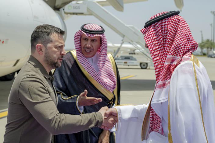 In this photo provided by Saudi Press Agency, SPA, Ukraine's President Volodymyr Zelenskyy, left, is greeted by Prince Badr Bin Sultan, deputy governor of Mecca, upon his arrival at Jeddah airport, Saudi Arabia, Friday, May 19, 2023, to attend the Arab summit. (Saudi Press Agency via AP)