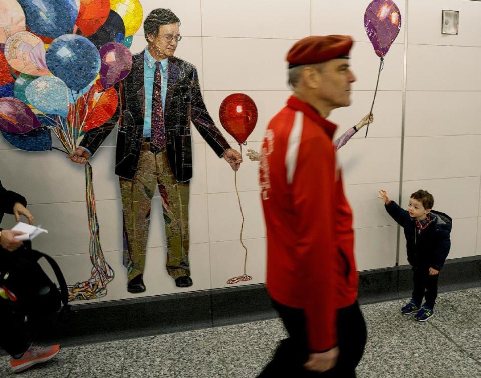 CORRECTS TO 72 ST. STATION, NOT 86 ST. - Guardian Angels founder Curtis Sliwa walks past the permanent installation of artist Vik Muniz's "Perfect Strangers" at the newly opened 72th Street Second Ave. Subway station in New York Sunday, Jan. 1, 2017. The opening of three new stations on the newly opened Second Ave. subway marks a decades long plan to bring rail transportation to Manhattan's Upper East Side. (AP Photo/Craig Ruttle)