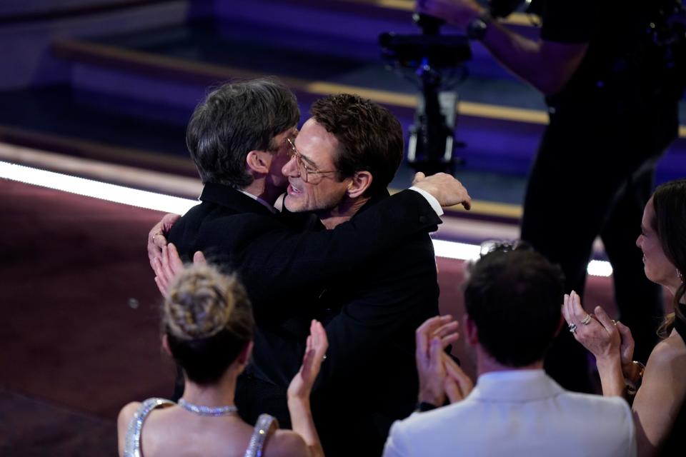 Cillian Murphy hugs Robert Downey Jr. as he heads to the stage to accept the award for best actor in a leading role for his role in "Oppenheimer" during the 96th Oscars at the Dolby Theatre at Ovation Hollywood in Los Angeles on March 10, 2024.