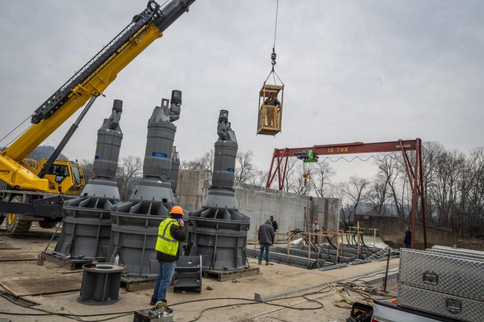 Workers prepare to install turbine-generators at a hydroelectric station on the Kentucky River in Estill County. The project offsets about half the electricity used by Berea College.