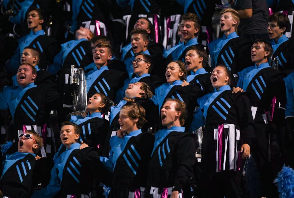 Lincoln marching band members cheer in unison from the stands on Friday, September 10, 2021 in the Presidents Bowl at Howard Wood Field in Sioux Falls.