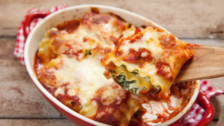 Spoon holding lasagna roll