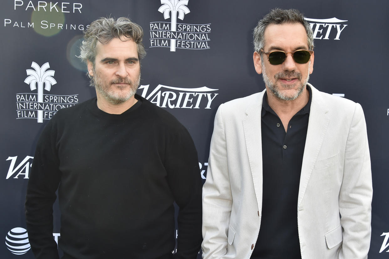 Todd Phillips (R), pictured here with Joaquin Phoenix, defended The Joker against backlash for its violence. (Photo by David Crotty/Patrick McMullan via Getty Images)