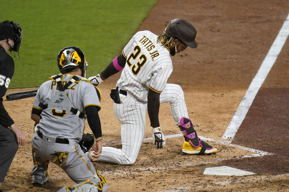 San Diego Padres' Fernando Tatis Jr. strikes out while batting as Pittsburgh Pirates catcher Michael Perez looks on, left, during the sixth inning of a baseball game Monday, May 3, 2021, in San Diego. (AP Photo/Gregory Bull)