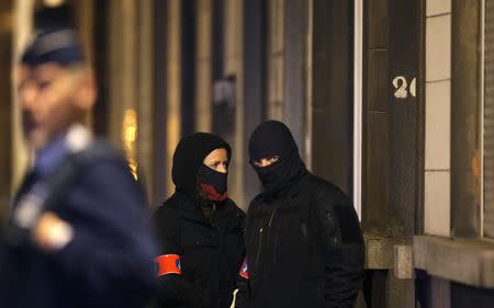 Masked Belgian police secure the entrance to a building in Schaerbeek during police operations following Tuesday's bomb attacks in Brussels, Belgium, March 25, 2016. REUTERS/Christian Hartmann