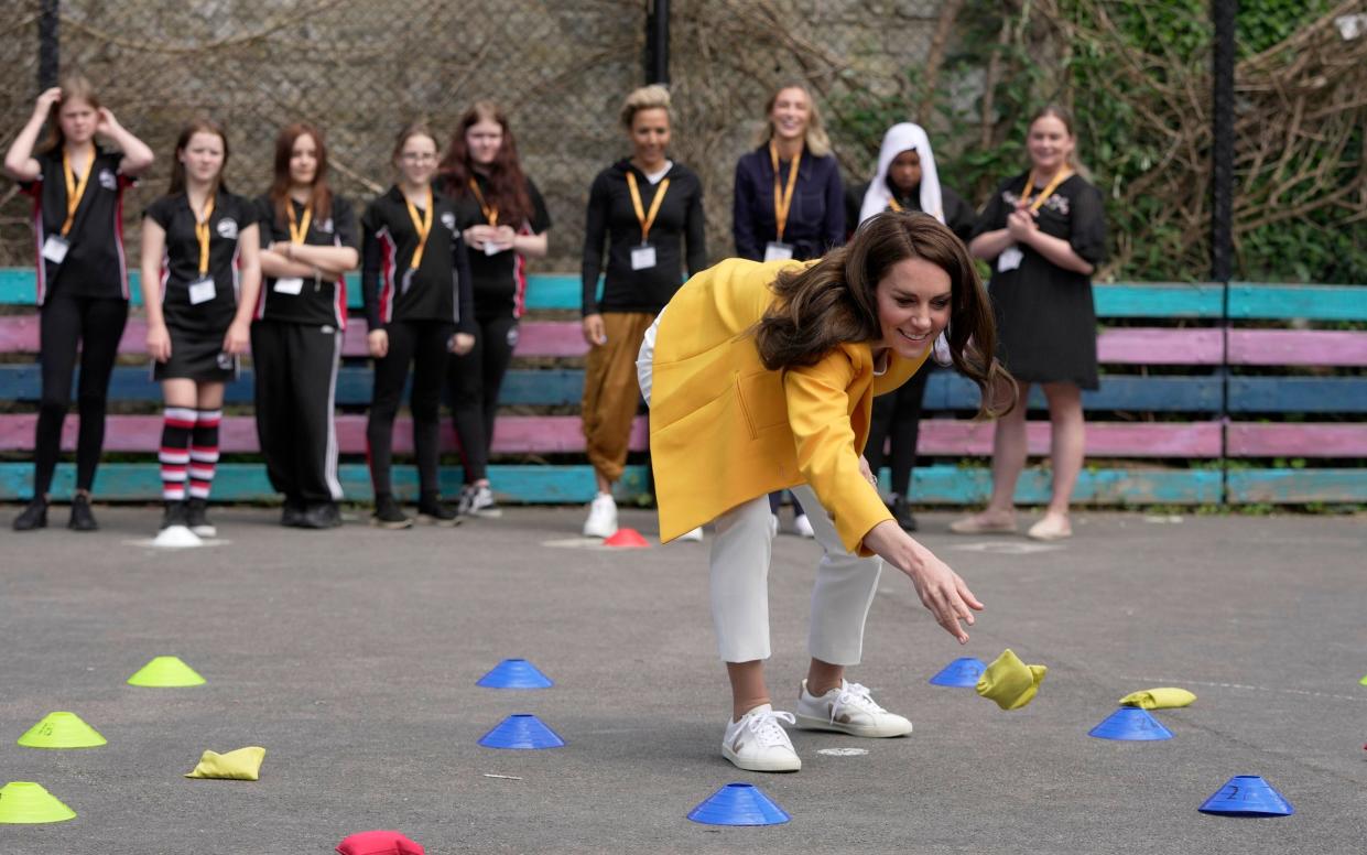 The Princess of Wales plays a match of bean-bag noughts and crosses with Dame Kelly Holmes and female pupils as she attended the double Olympic champion's youth development charity event in Bath - AP/Kin Cheung
