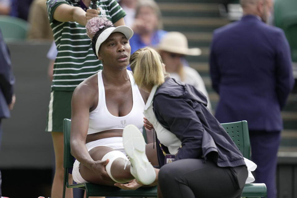 Venus Williams of the US gets medical treatment during a timeout as she plays Ukraine's Elina Svitolina in a first round women's singles match on day one of the Wimbledon tennis championships in London, Monday, July 3, 2023. (AP Photo/Kin Cheung)