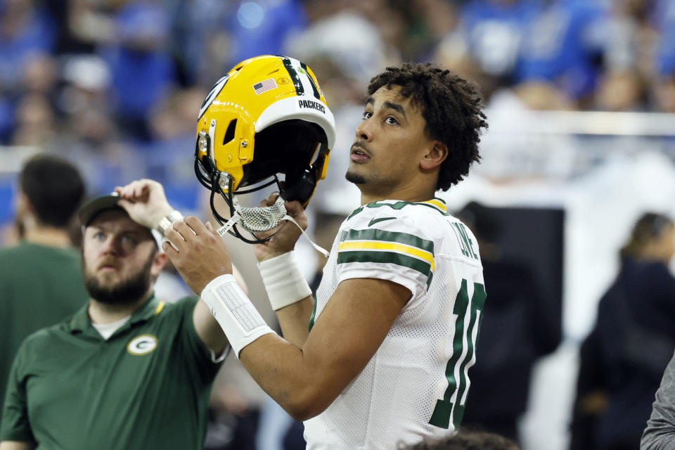 Green Bay Packers quarterback Jordan Love puts on his helmet during the first half of an NFL football game against the Detroit Lions, Thursday, Nov. 23, 2023, in Detroit. (AP Photo/Duane Burleson)