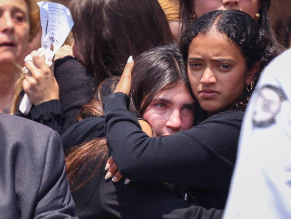 Classmates embrace after the funeral service for 15-year-old Ella Riley Adler that was held at Temple Beth Sholom on Monday, May 13, 2024, in Miami Beach, Florida.
